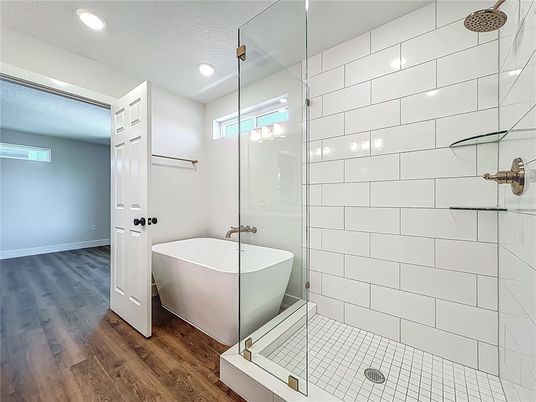 Bathroom, Free Standing Baths, Glass Shower, Interior, Recessed Lighting, Wood Texture Flooring