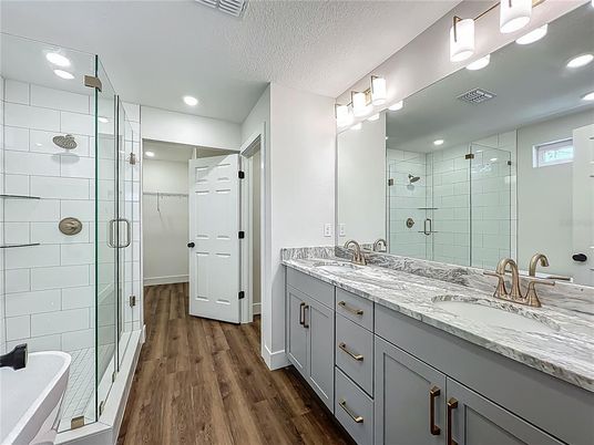 Bathroom, Dual Sink Vanities, Glass Shower, Interior, Recessed Lighting, Wood Texture Flooring