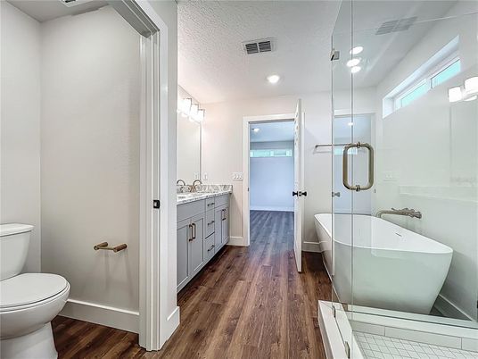 Bathroom, Dual Sink Vanities, Free Standing Baths, Glass Shower, Interior, Recessed Lighting, Wood Texture Flooring