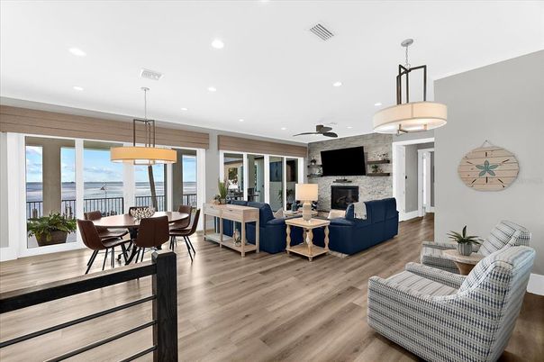 Dining room, Fireplace, Interior, Living room, Pendant Lights, Recessed Lighting, Stone Walls, Water, Wood Texture Flooring