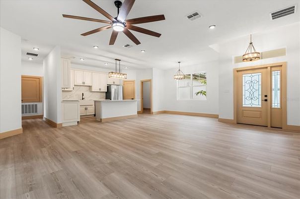 Chandelier, Empty room, Interior, Kitchen, Pendant Lights, Recessed Lighting, Stainless Steel Appliances, Wood Texture Flooring
