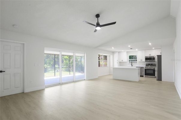 Empty room, Interior, Kitchen, Recessed Lighting, Stainless Steel Appliances, Wood Texture Flooring