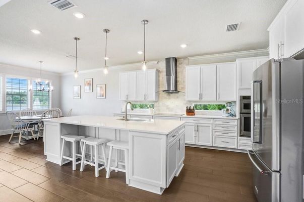 Chandelier, Dining room, Interior, Kitchen, Pendant Lights, Recessed Lighting, Stainless Steel Appliances, Wood Texture Flooring