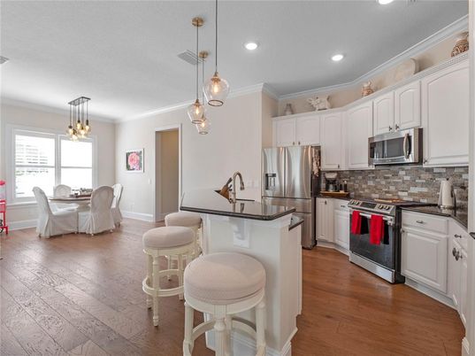 Dining room, Interior, Kitchen, Pendant Lights, Recessed Lighting, Stainless Steel Appliances, Wood Texture Flooring