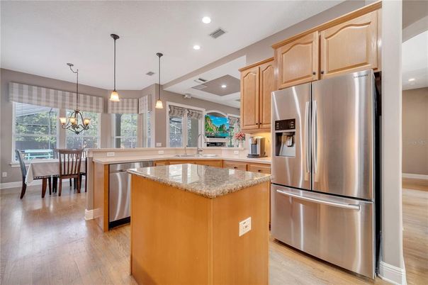 Chandelier, Dining room, Interior, Kitchen, Pendant Lights, Recessed Lighting, Stainless Steel Appliances, Wood Texture Flooring