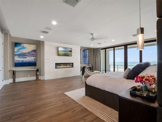 Bedroom, Fireplace, Interior, Pendant Lights, Recessed Lighting, Water, Wood Texture Flooring