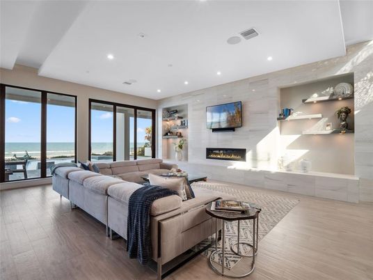 Fireplace, Interior, Living room, Recessed Lighting, Stone Walls, Water, Wood Texture Flooring