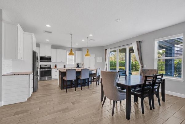 Dining room, Interior, Kitchen, Pendant Lights, Recessed Lighting, Stainless Steel Appliances, Wood Texture Flooring
