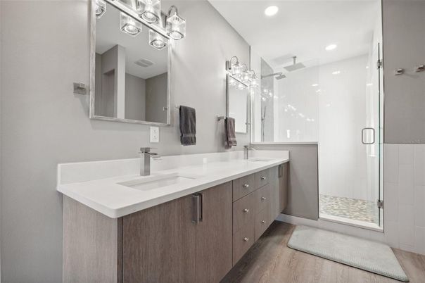 Bathroom, Dual Sink Vanities, Glass Shower, Interior, Recessed Lighting, Wood Texture Flooring