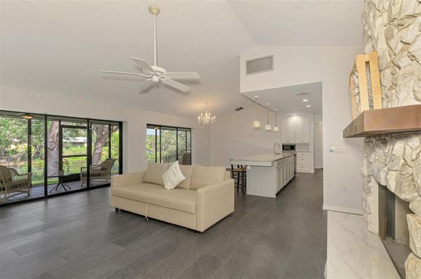 Chandelier, Fireplace, Interior, Kitchen, Living room, Pendant Lights, Recessed Lighting, Stone Walls, Wood Texture Flooring