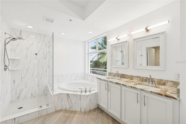 Bathroom, Dual Sink Vanities, Glass Shower, Interior, Marble Walls, Recessed Lighting, Wood Texture Flooring