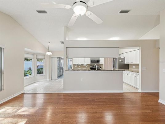 Empty room, Interior, Kitchen, Pendant Lights, Stainless Steel Appliances, Wood Texture Flooring