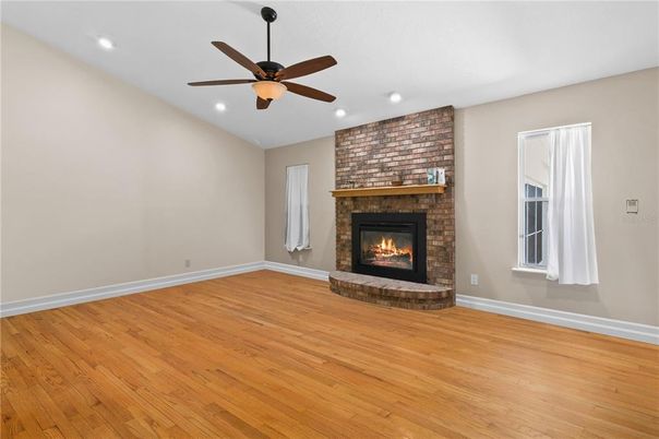 Empty room, Fireplace, Interior, Recessed Lighting, Stone Walls, Wood Texture Flooring