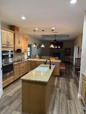 Fireplace, Interior, Kitchen, Pendant Lights, Recessed Lighting, Stainless Steel Appliances, Wood Texture Flooring