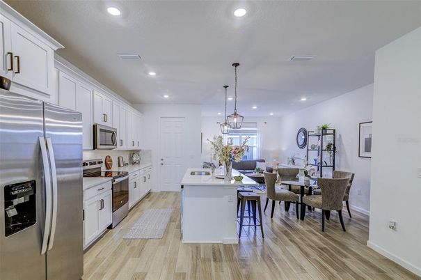 Dining room, Interior, Kitchen, Pendant Lights, Recessed Lighting, Stainless Steel Appliances, Wood Texture Flooring