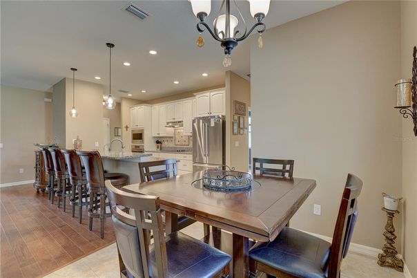 Dining room, Interior, Kitchen, Pendant Lights, Recessed Lighting, Stainless Steel Appliances, Wood Texture Flooring