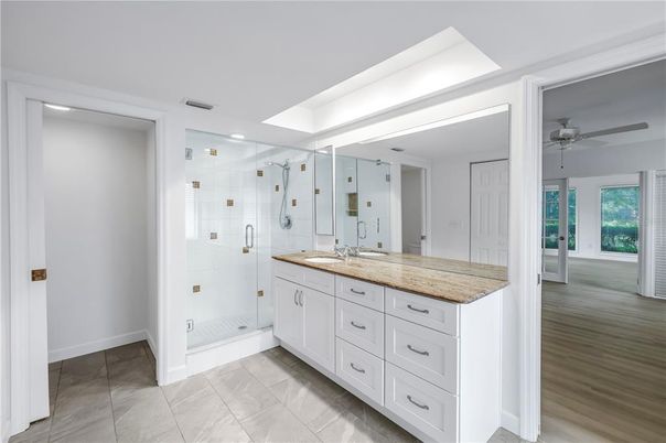 Bathroom, Dual Sink Vanities, Glass Shower, Interior, Recessed Lighting, Wood Texture Flooring