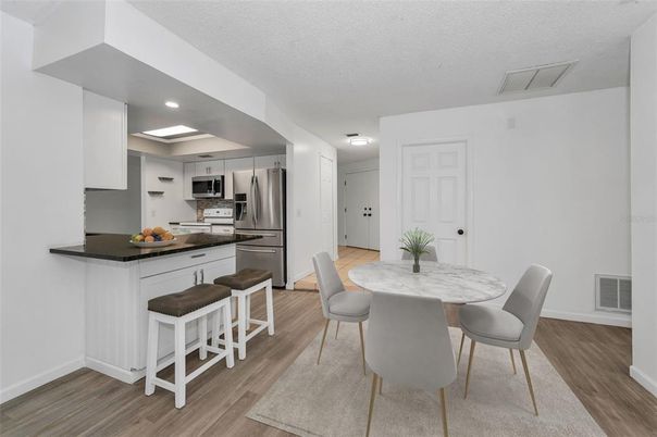 Dining room, Interior, Kitchen, Recessed Lighting, Stainless Steel Appliances, Wood Texture Flooring