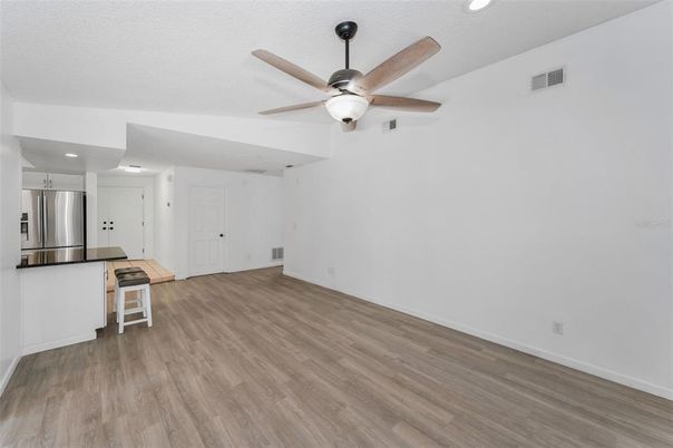 Empty room, Interior, Kitchen, Recessed Lighting, Stainless Steel Appliances, Wood Texture Flooring