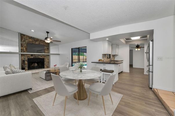 Dining room, Fireplace, Interior, Kitchen, Living room, Recessed Lighting, Stone Walls, Wood Texture Flooring