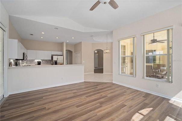 Empty room, Interior, Kitchen, Pendant Lights, Recessed Lighting, Stainless Steel Appliances, Wood Texture Flooring