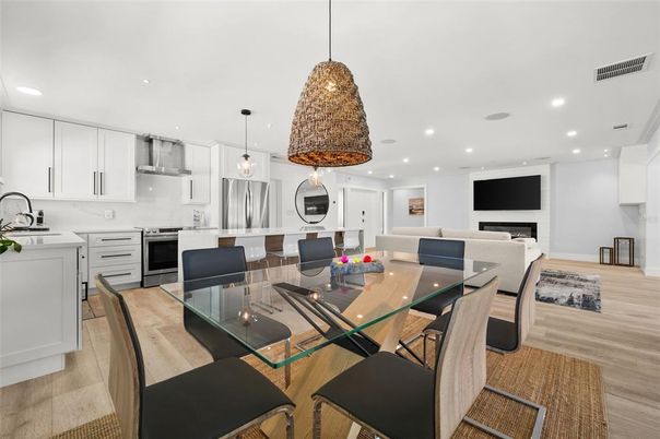 Dining room, Fireplace, Interior, Kitchen, Pendant Lights, Recessed Lighting, Stainless Steel Appliances, Wood Texture Flooring