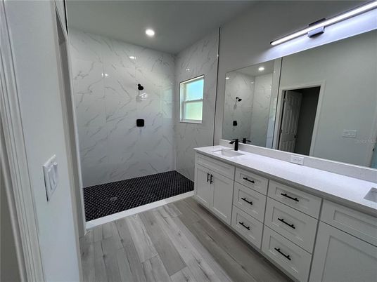 Bathroom, Dual Sink Vanities, Interior, Marble Walls, Recessed Lighting, Wood Texture Flooring