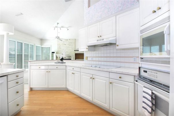 Interior, Kitchen, Pendant Lights, Tile Countertops, Wood Texture Flooring