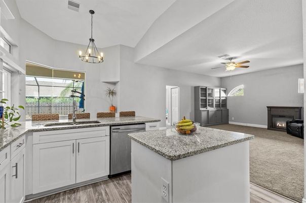 Chandelier, Fireplace, Interior, Kitchen, Pendant Lights, Recessed Lighting, Wood Texture Flooring