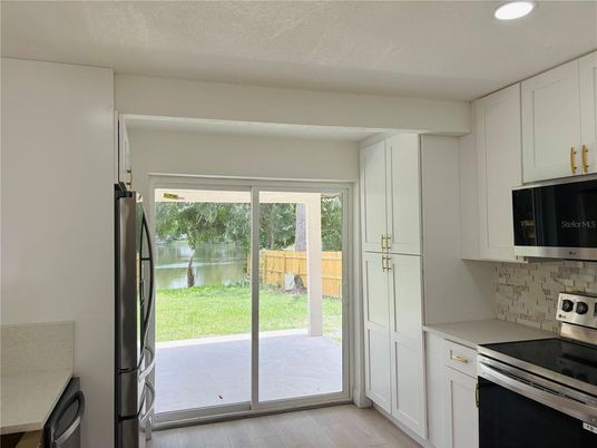Interior, Kitchen, Recessed Lighting, Stainless Steel Appliances, Wood Texture Flooring