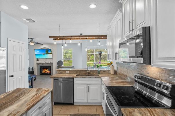 Fireplace, Interior, Kitchen, Pendant Lights, Recessed Lighting, Stainless Steel Appliances