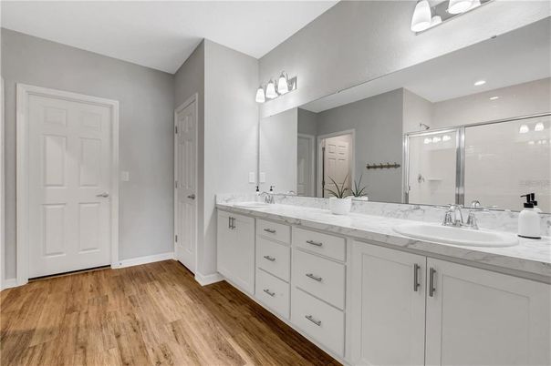Bathroom, Dual Sink Vanities, Glass Shower, Interior, Recessed Lighting, Wood Texture Flooring