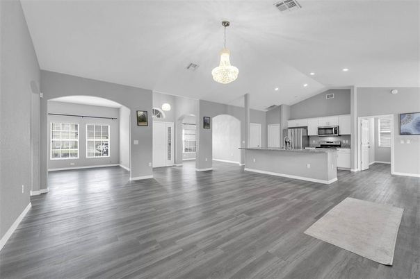 Chandelier, Empty room, Interior, Kitchen, Pendant Lights, Recessed Lighting, Stainless Steel Appliances, Wood Texture Flooring