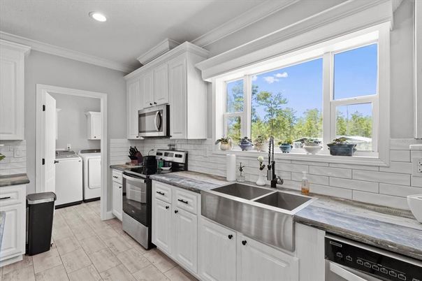 Interior, Kitchen, Recessed Lighting, Washer, Wood Texture Flooring