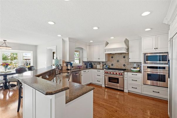 Dining room, Interior, Kitchen, Pendant Lights, Recessed Lighting, Stainless Steel Appliances, Wood Texture Flooring