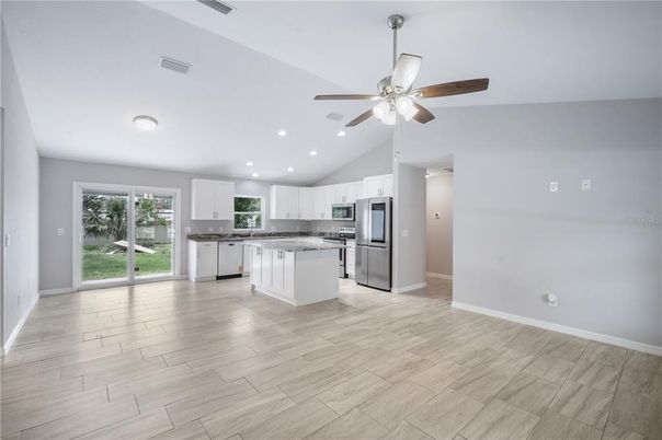 Empty room, Interior, Kitchen, Recessed Lighting, Stainless Steel Appliances, Wood Texture Flooring