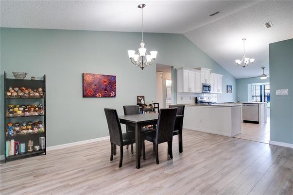 Chandelier, Dining room, Interior, Kitchen, Pendant Lights, Stainless Steel Appliances, Wood Texture Flooring