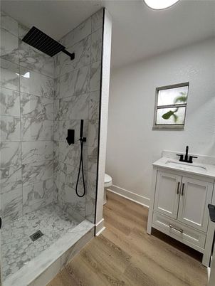 Bathroom, Glass Shower, Interior, Marble Walls, Recessed Lighting, Wood Texture Flooring