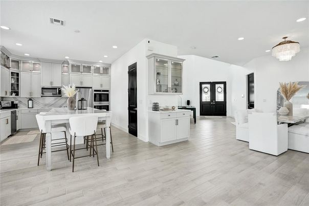 Chandelier, Dining room, Interior, Kitchen, Recessed Lighting, Stainless Steel Appliances, Wood Texture Flooring
