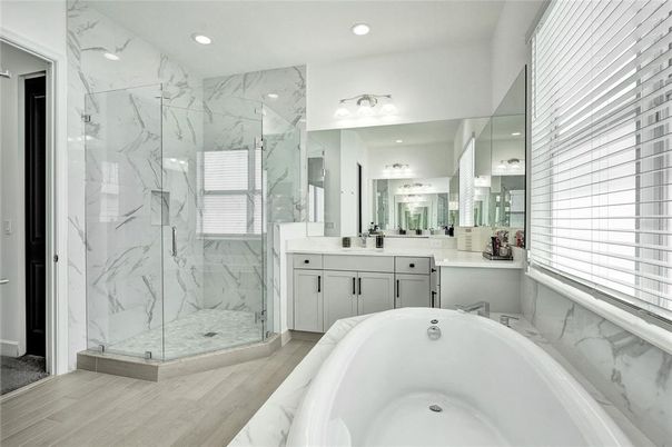Bathroom, Dual Sink Vanities, Free Standing Baths, Glass Shower, Interior, Marble Walls, Recessed Lighting, Wood Texture Flooring