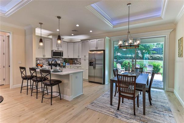 Chandelier, Dining room, Interior, Kitchen, Pendant Lights, Recessed Lighting, Stainless Steel Appliances, Wood Texture Flooring