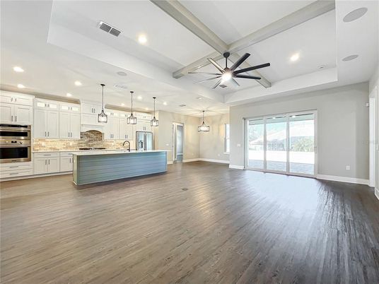 Empty room, Interior, Kitchen, Pendant Lights, Recessed Lighting, Stainless Steel Appliances, Wood Texture Flooring