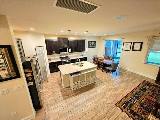 Dining room, Interior, Kitchen, Pendant Lights, Recessed Lighting, Stainless Steel Appliances, Wood Texture Flooring