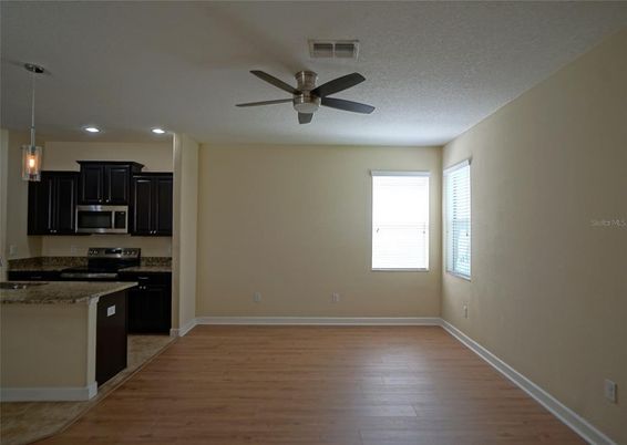 Empty room, Interior, Kitchen, Pendant Lights, Recessed Lighting, Stainless Steel Appliances, Wood Texture Flooring