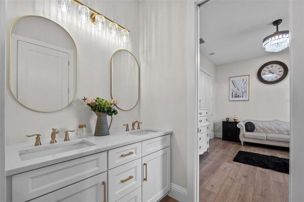 Bathroom, Chandelier, Dual Sink Vanities, Interior, Wood Texture Flooring