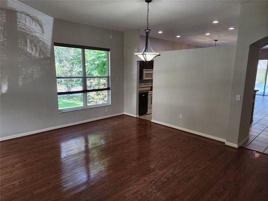 Empty room, Interior, Kitchen, Pendant Lights, Recessed Lighting, Stainless Steel Appliances, Wood Texture Flooring