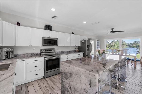 Dining room, Interior, Kitchen, Recessed Lighting, Stainless Steel Appliances, Water, Wood Texture Flooring