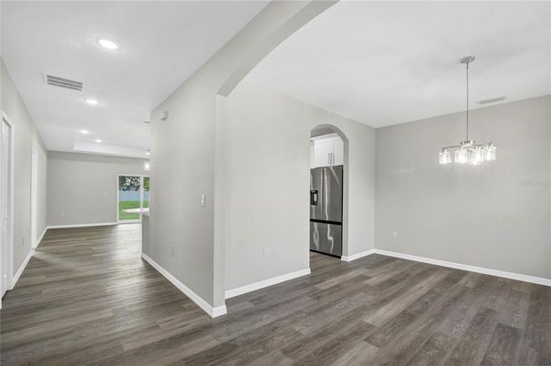 Empty room, Interior, Kitchen, Pendant Lights, Recessed Lighting, Stainless Steel Appliances, Wood Texture Flooring