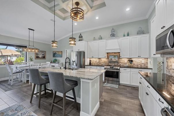 Dining room, Interior, Kitchen, Pendant Lights, Recessed Lighting, Stainless Steel Appliances, Wood Texture Flooring
