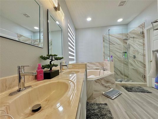 Bathroom, Dual Sink Vanities, Glass Shower, Interior, Marble Walls, Recessed Lighting, Wood Texture Flooring